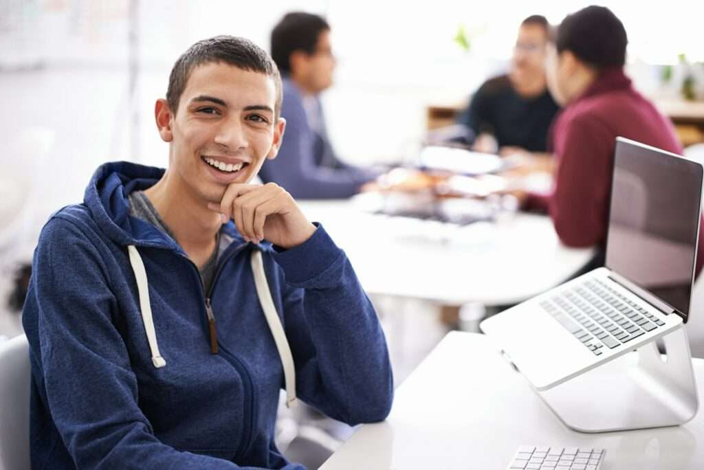 Cropped shot of a handsome young man working on his laptop in an office