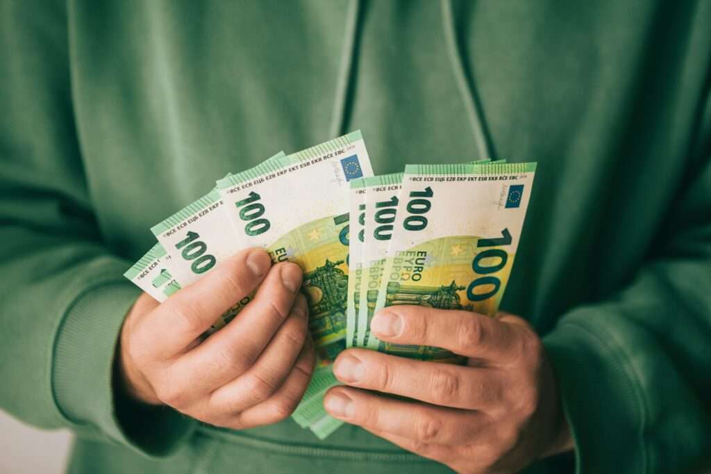 Holding money, hands with money, counting money, euro bills