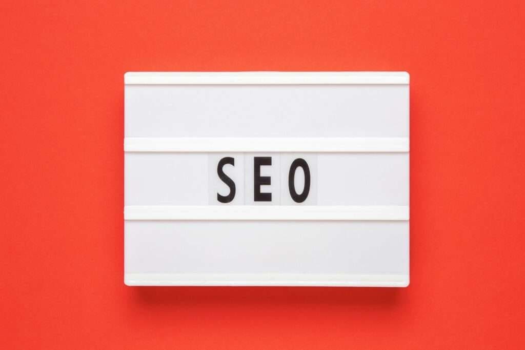 Lightbox with word SEO on red background. Search Engine Optimization ranking concept.